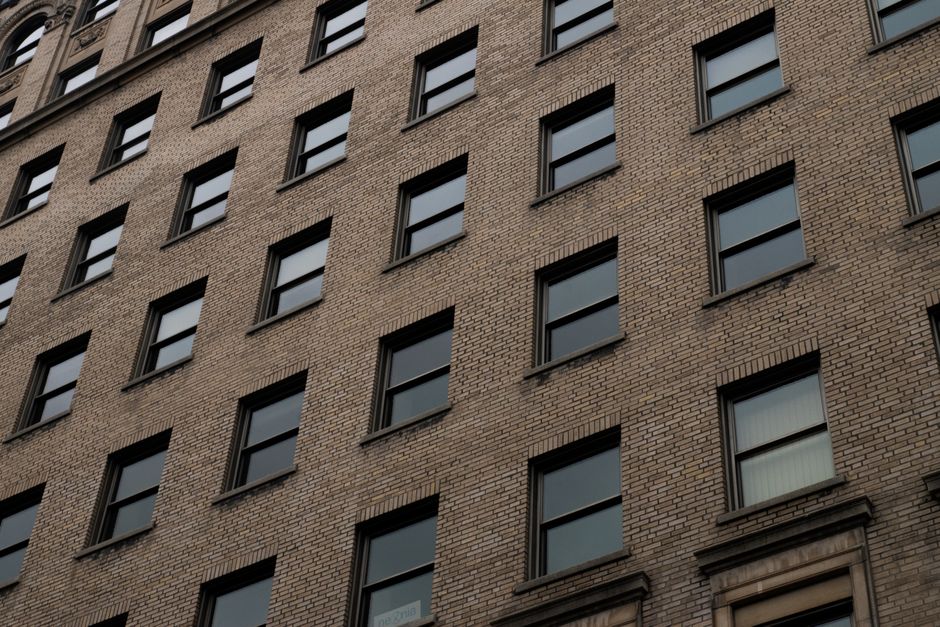 Framer vs Webflow: Portfolio Site Design Without Coding (2024) Close-up view of a modern brick building facade featuring symmetrical windows.