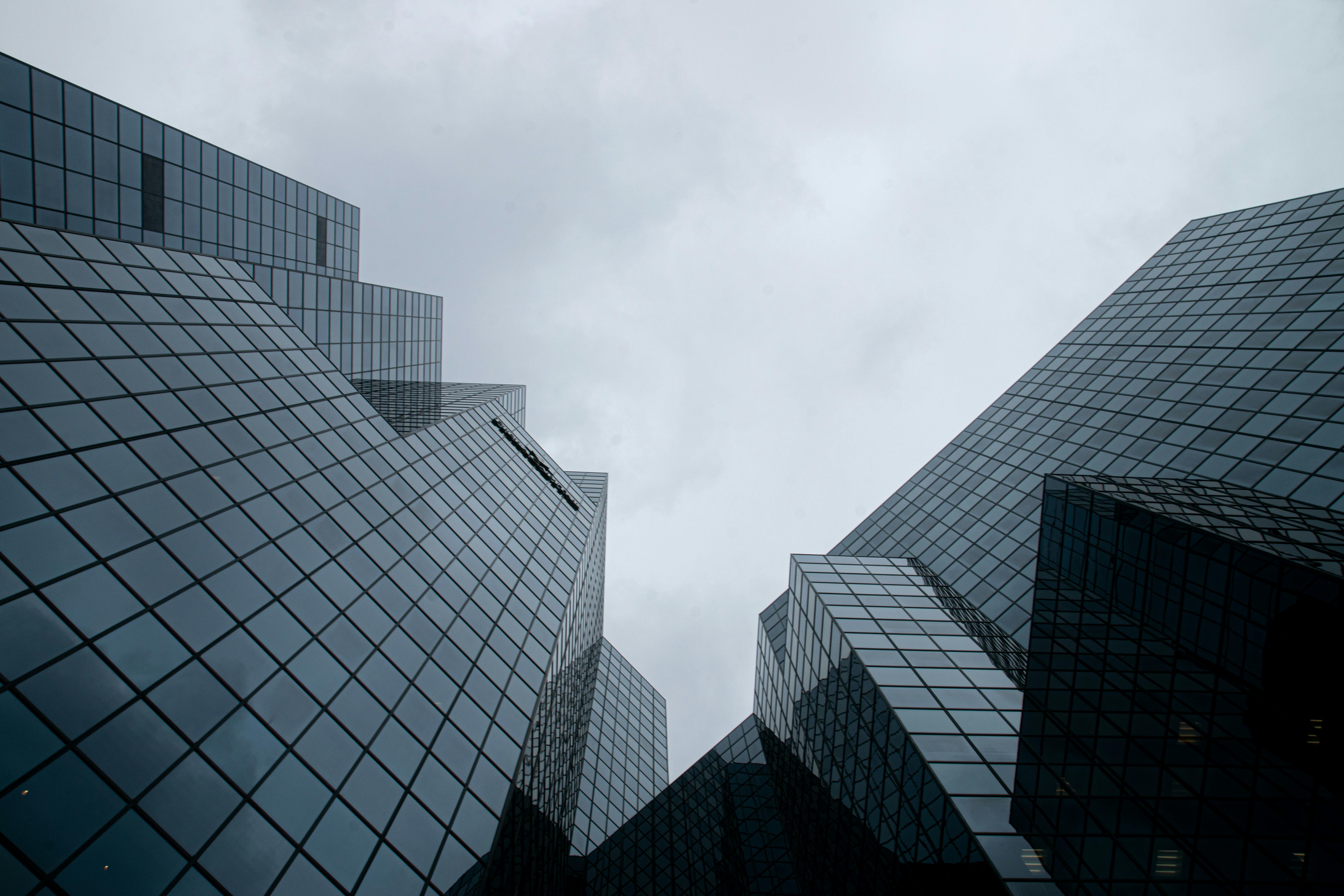 Concrete Building Under White Clouds · Free Stock Photo