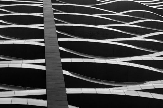 Black and white abstract view of modern architecture showcasing wave-like patterns.