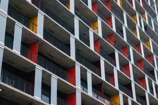 A visually striking exterior of a modern apartment building with colorful balconies.