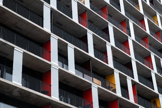 Close-up view of a modern apartment building with vibrant balconies.