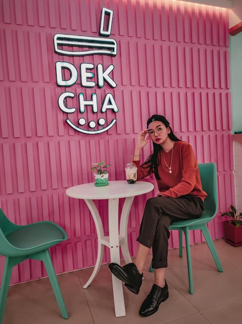 A Woman Sitting on Green Chair