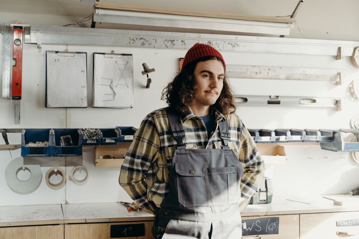 Sam Porter, designer, in front of the tool wall