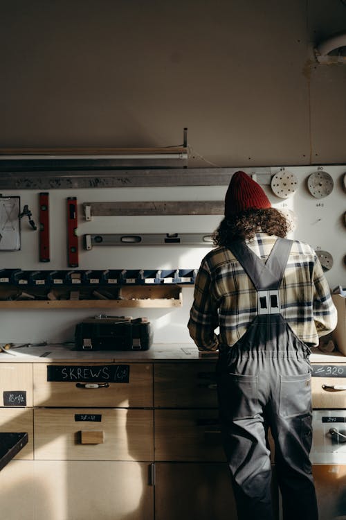 Woman in Gray Jumper Working at the Counter