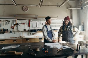 Two organisers reviewing plans in a workshop — cottonbro studio on Pexels