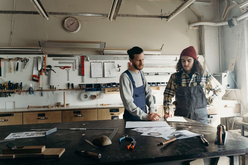 Engineers reviewing design blueprints in a workshop