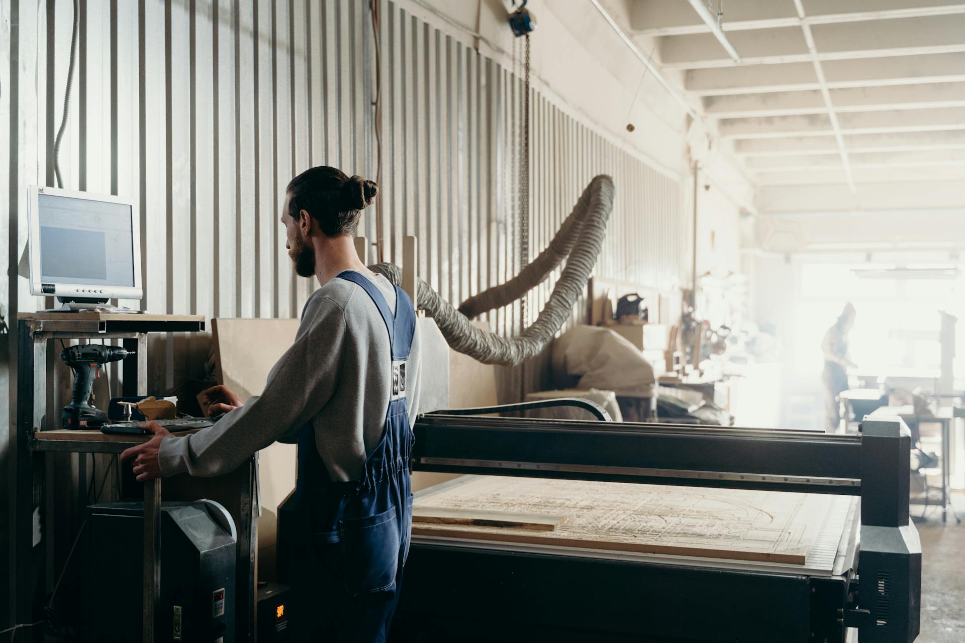 A Man Standing in Front of the Computer