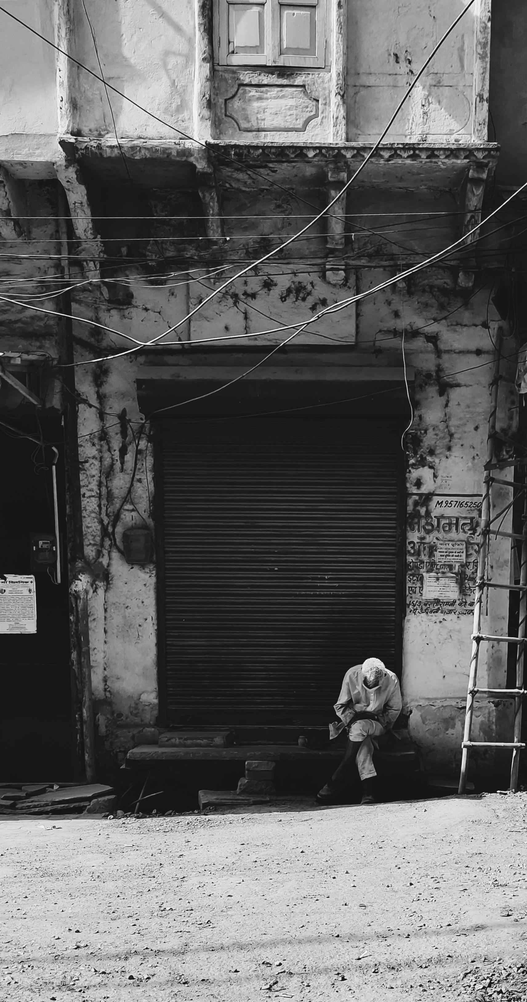 A monochrome image showcasing a solitary figure in Boharwadi, India.