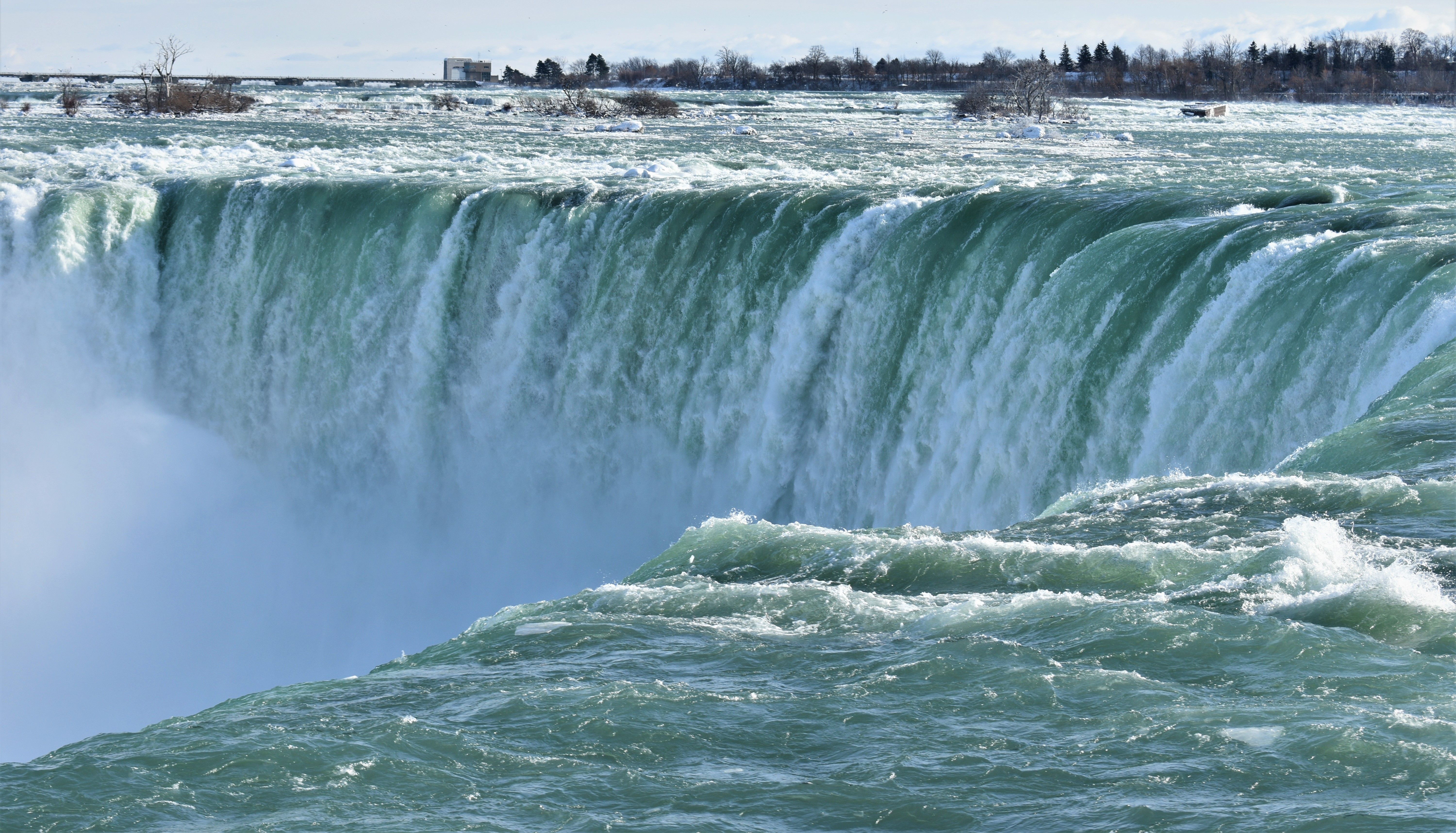 Stunning view of Niagara Falls with icy waters cascading in winter.