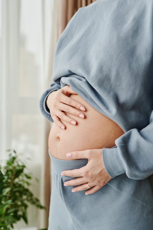 Free Pregnant Woman Touching Her Belly Stock Photo