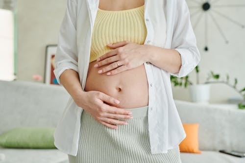 Free A Pregnant Woman Holding her Belly Stock Photo