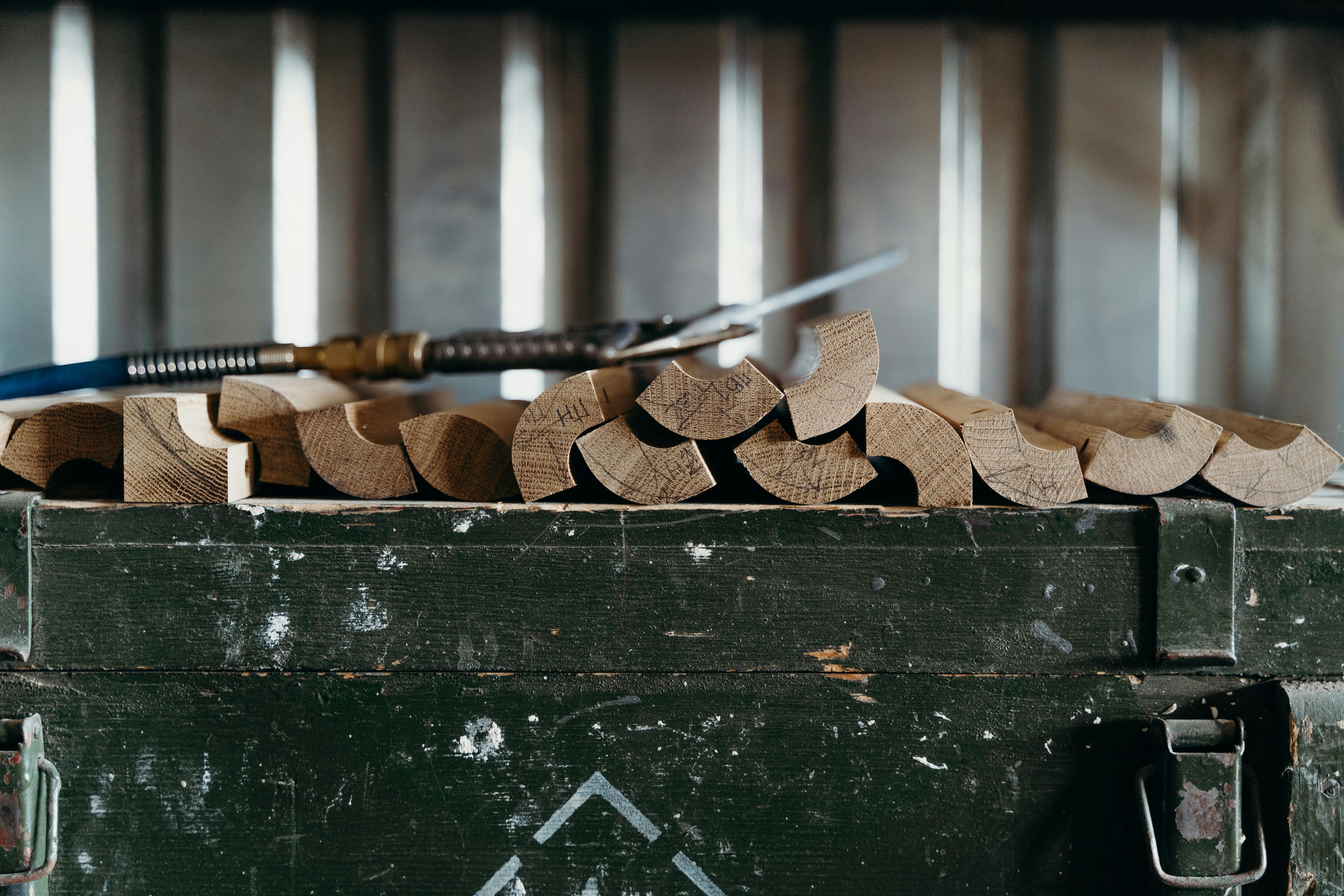 Stacks of shaped timber pieces in a workshop, suggesting the less polished, more lived-in Australian interior these makers are arguing for.