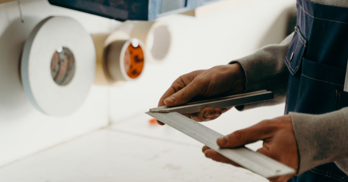 A Person Holding an Angle Ruler · Free Stock Photo