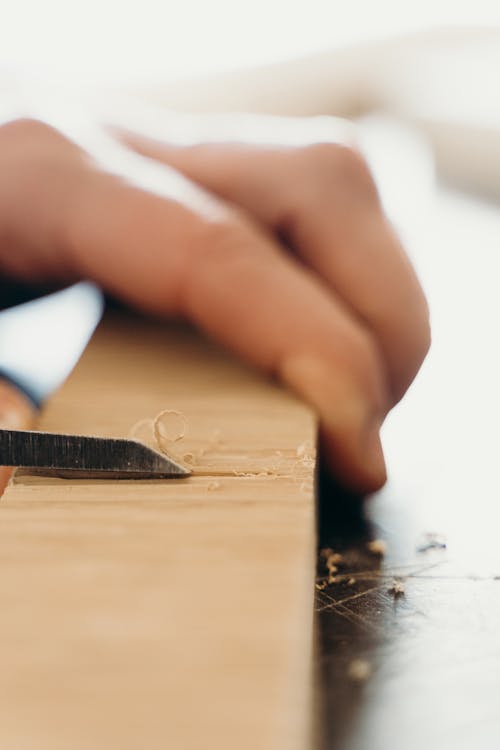 A Person Holding a Chisel