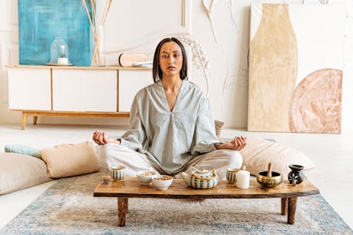 Woman Meditating on Carpet