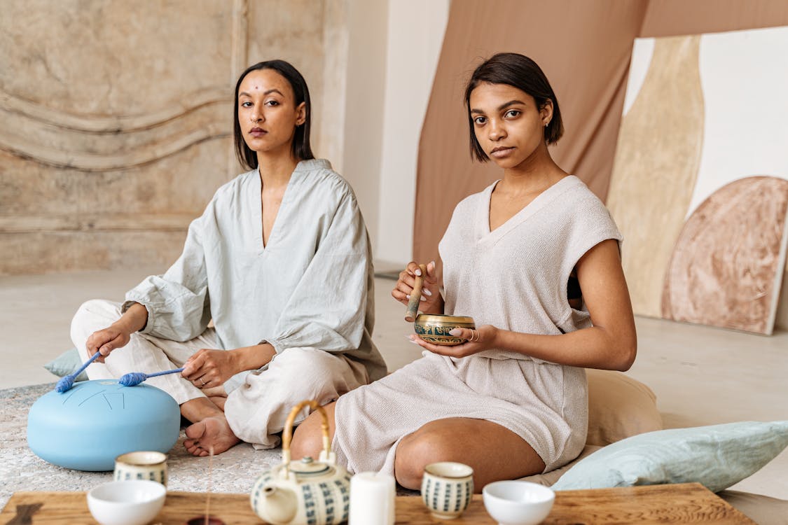 Women Sitting on the Floor while Doing Meditation