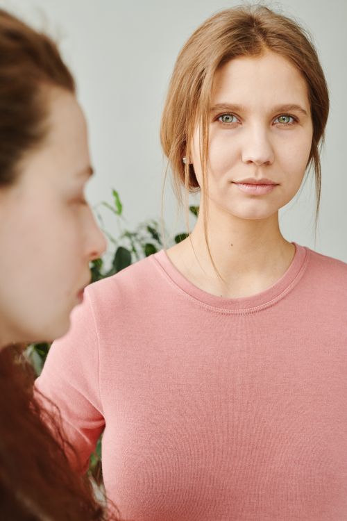 Free A serene portrait of two women in natural light, emphasizing calm and connection. Stock Photo