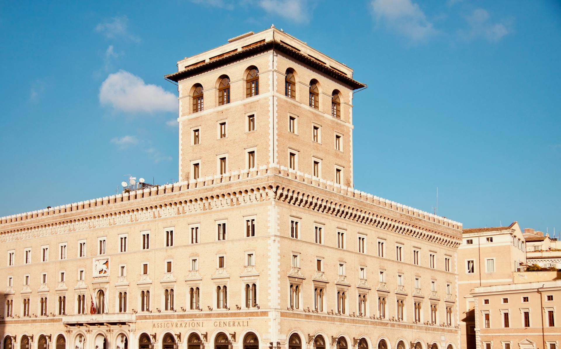 Elegant Palazzo in Rome with intricate facade under a clear blue sky, ideal for travel and architecture themes.