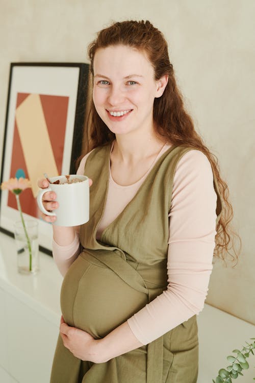 Pregnant Woman Holding a Cup