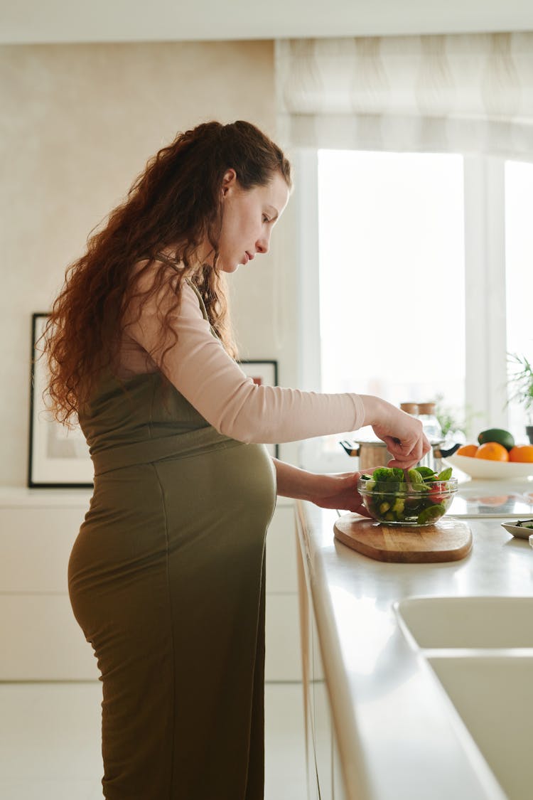 A Pregnant Woman Preparing Food