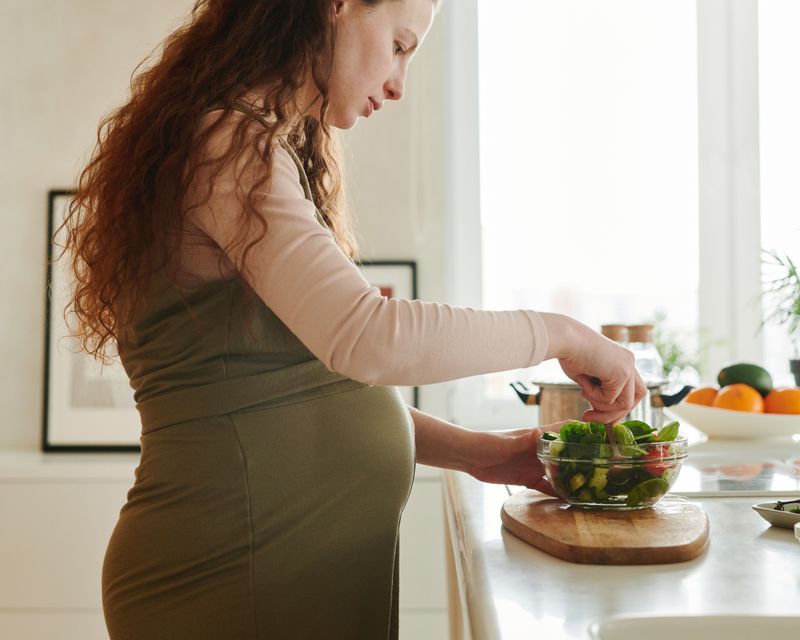 Pregnant mom preparing a fresh meal at home