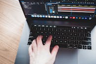 Unrecognizable person typing on laptop keyboard