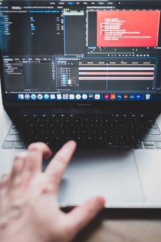 Crop unrecognizable male programmer typing on netbook while working on project and creating music
