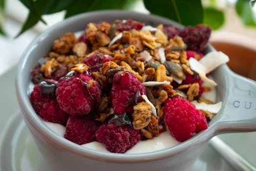 Raspberries and Nuts on Ceramic Bowl