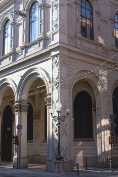 Capture of a classic exterior with arched columns and decorative details in natural light.