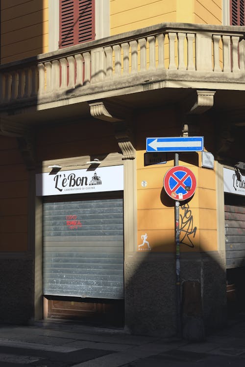 Road Signs on Pole Outside Building