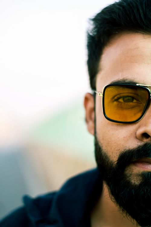 Free Stylish bearded man with sunglasses captured in an artistic close-up photograph. Stock Photo