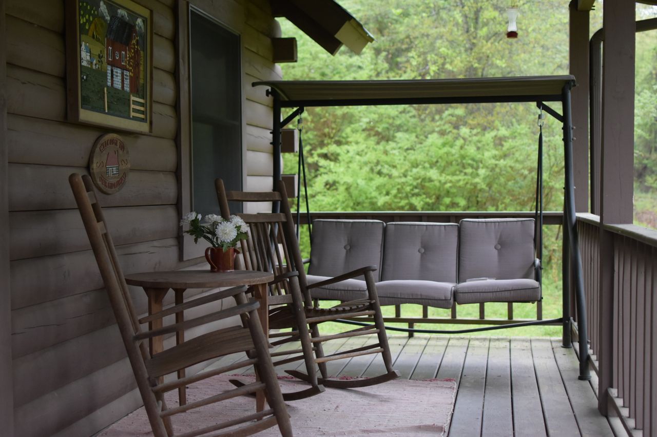 Wooden rocking chairs on a covered porch