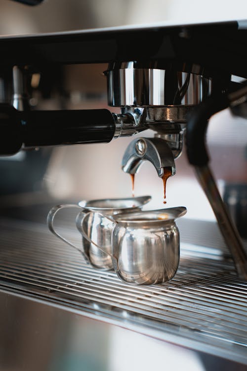 Photo of Espresso Dripping on a Small Stainless Mug