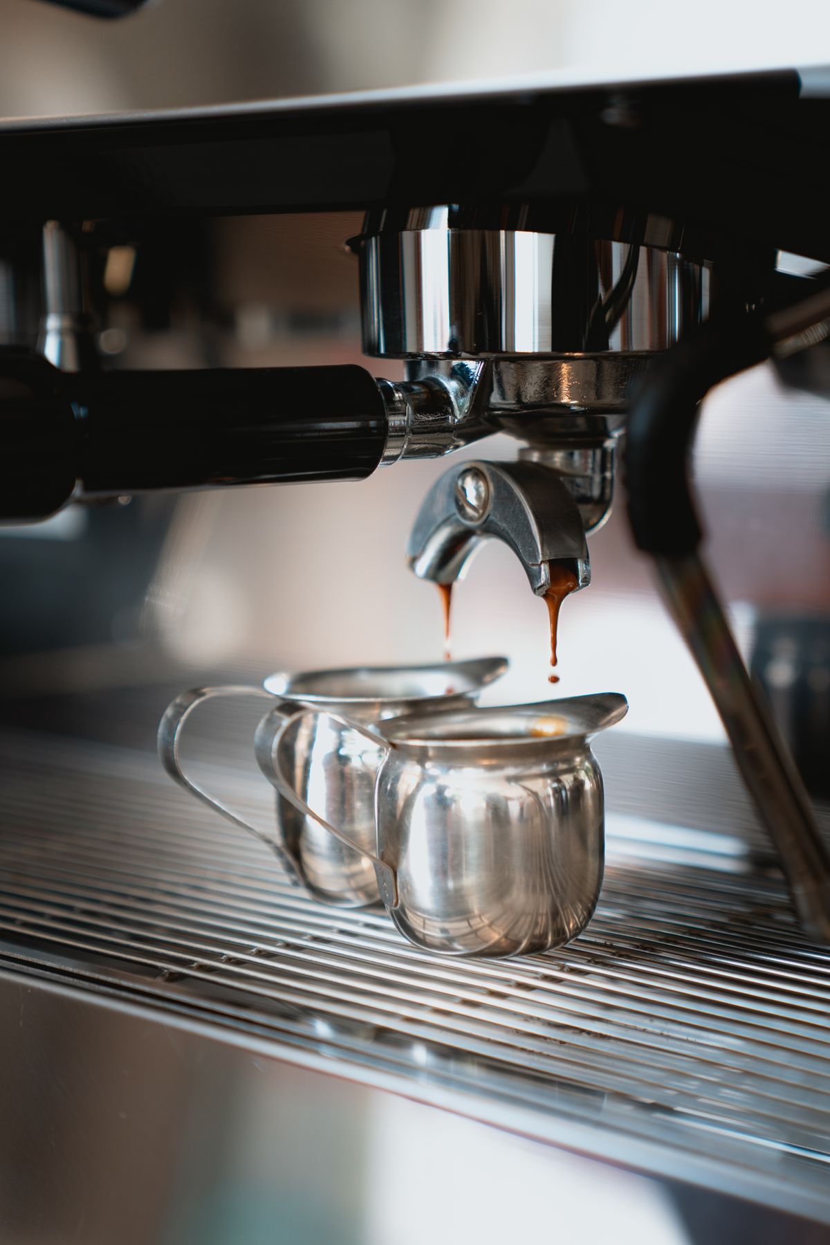 Chrome espresso machine pulling a shot, for illustration