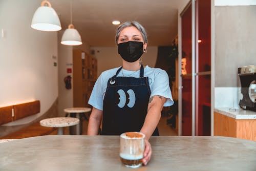 Photo of Barista Serving Iced Coffee