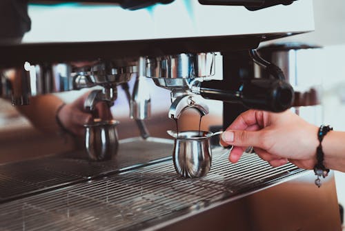 Photo of Pouring of Espresso on Stainless Cup