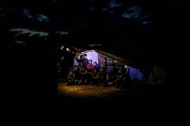 A People Sitting Outside The House