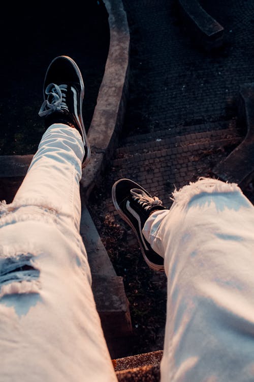 Person in Denim Jeans and Black Sneakers · Free Stock Photo