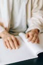 A Person Touching a Braille Book