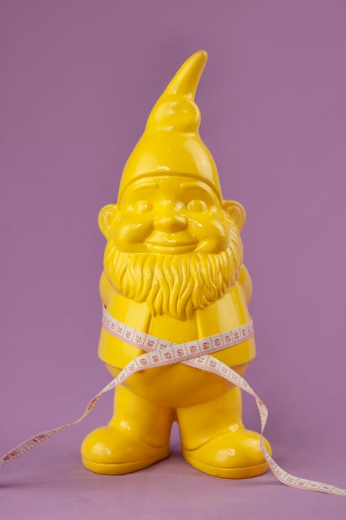 Composition of garden gnome and tape
