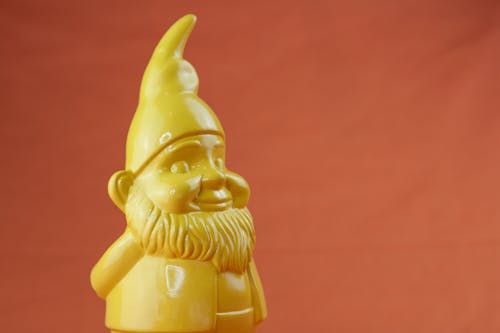 Free Closeup yellow figurine on red background Stock Photo