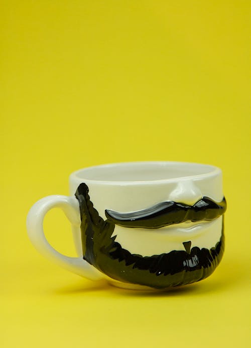White cup with black beard and mustache