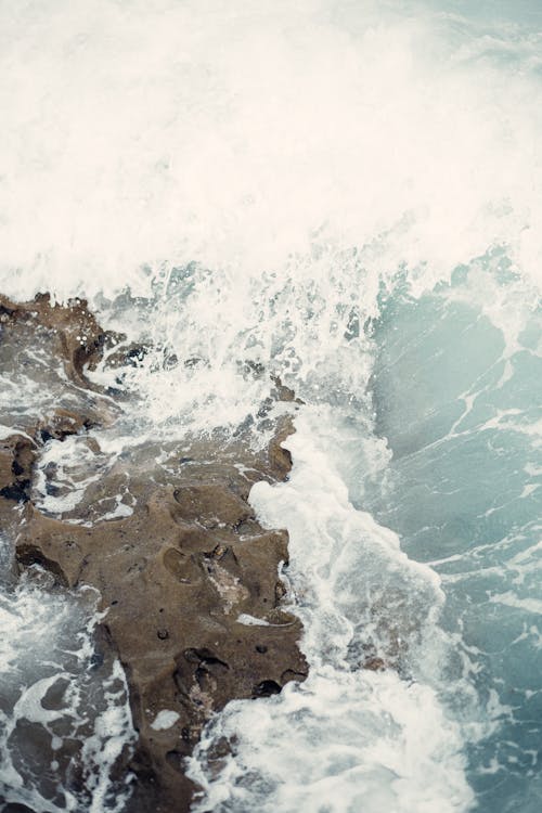 A Top View of a Rock with Ocean Waves