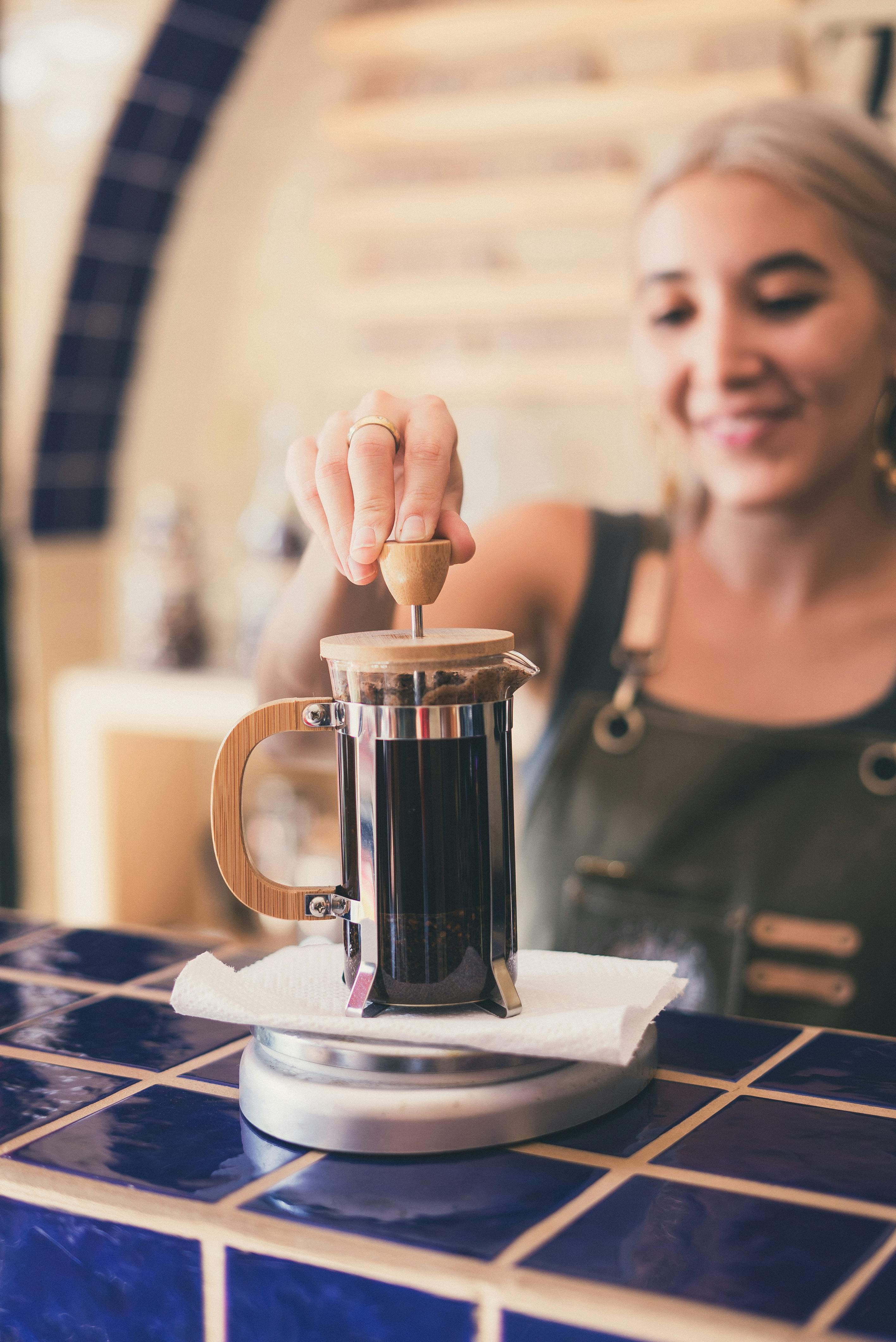 photo of woman using french press