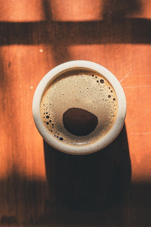 Photo of Cup of Coffee on Top of Wooden Surface