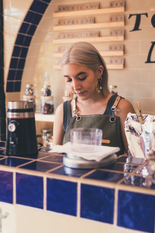 Photo of Woman Standing Behind the Counter