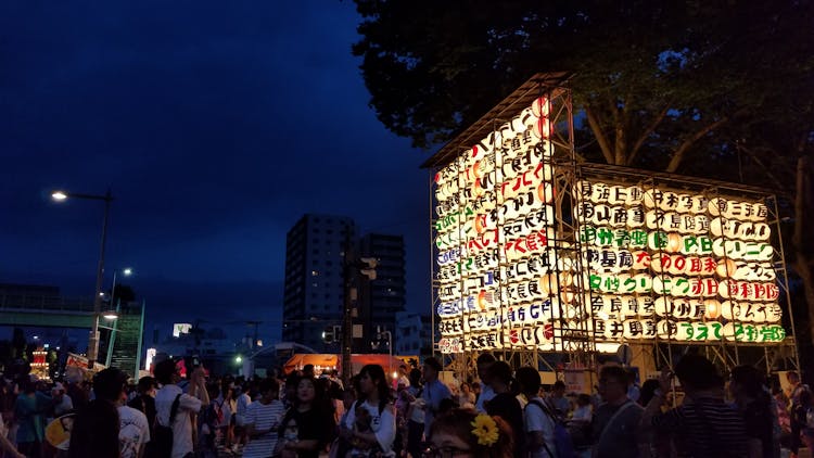 Group Of People Near Multicolored Lantern Display