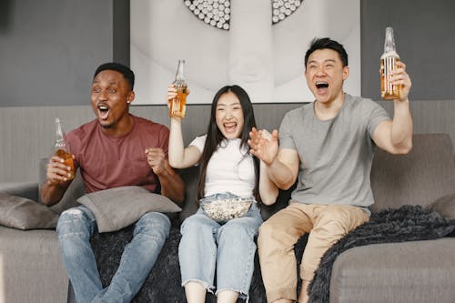 Free A Happy People holding Beer while Sitting  Stock Photo