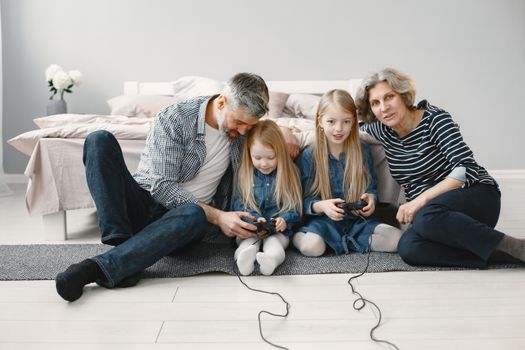 Happy family enjoying leisure time and bonding through gaming at home.