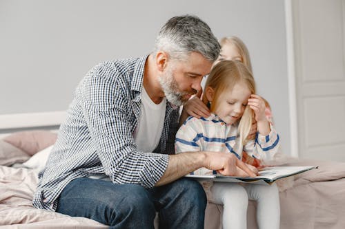 A Father Teaching His Daughter How to Read